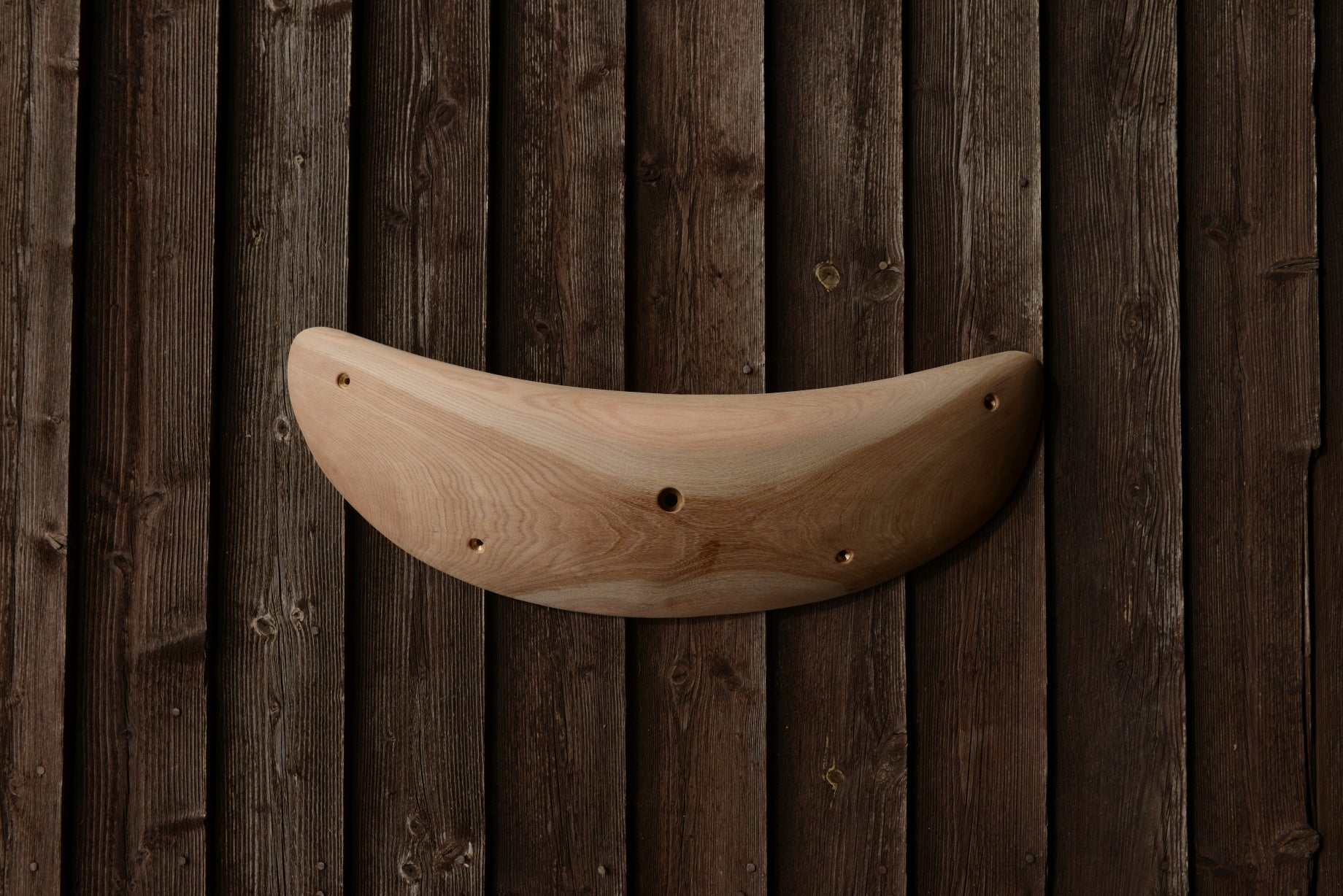 A carved elm jug/sloper. Type of wood: elm. Dimensions(LxWxH): 63x22x9. Eco-friendly holds for modern indoor climbing.