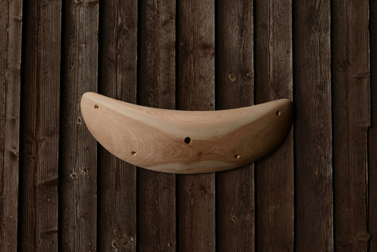 A carved elm jug/sloper. Type of wood: elm. Dimensions(LxWxH): 63x22x9. Eco-friendly holds for modern indoor climbing.